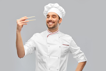 Image showing happy smiling male chef with chopsticks