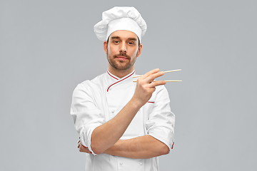 Image showing serious male chef with chopsticks