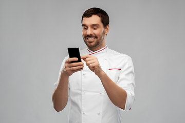 Image showing happy smiling male chef with smartphone