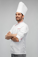 Image showing happy smiling male chef in toque with crossed arms