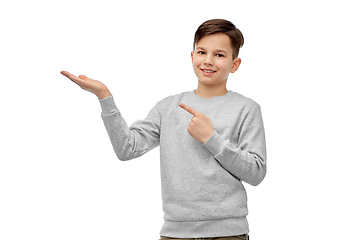 Image showing happy boy holding something imaginary on hand