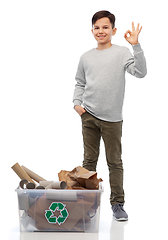 Image showing smiling boy sorting paper waste showing ok sign