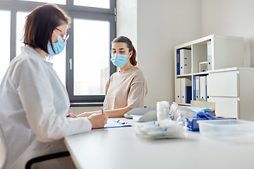 Image showing doctor with clipboard and patient at hospital