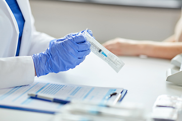 Image showing female doctor with syringe and patient at hospital