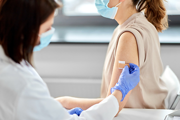 Image showing close up of doctor attaching patch to patient