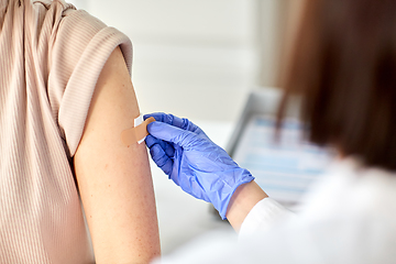 Image showing close up of doctor attaching patch to patient