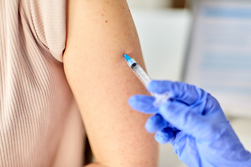 Image showing close up of hand with syringe vaccinating patient