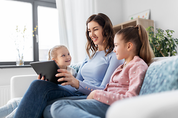 Image showing happy mother and daughters with tablet pc at home