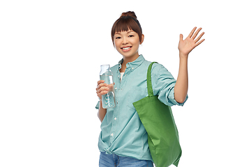 Image showing woman with bag for food shopping and glass bottle