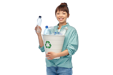 Image showing smiling young asian woman sorting plastic waste