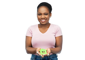 Image showing smiling african american woman holding green house