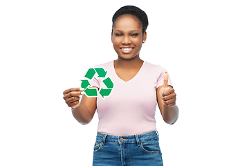 Image showing smiling asian woman holding green recycling sign