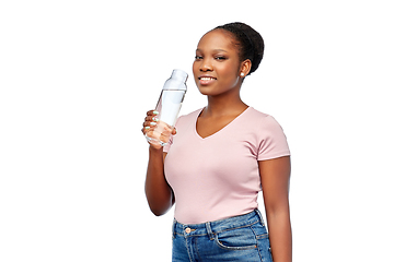 Image showing happy african woman drinks water from glass bottle