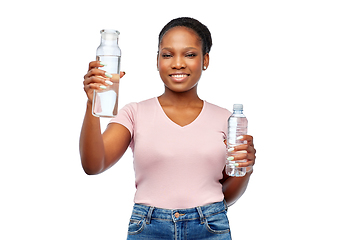 Image showing happy woman with plastic and glass bottle of water