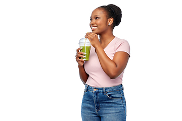 Image showing happy african american woman drinking green juice