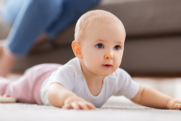 Image showing little baby girl crawling on floor at home