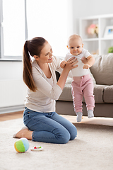 Image showing happy mother playing with little baby at home