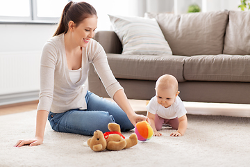 Image showing happy mother playing with little baby at home