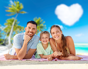 Image showing happy family lying over tropical beach background