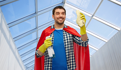 Image showing smiling man in superhero cape with rag and cleaner