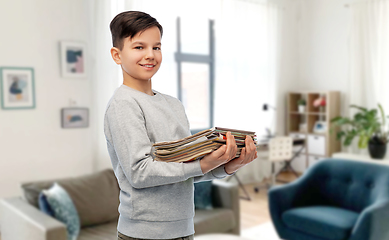 Image showing smiling boy with magazines sorting paper waste