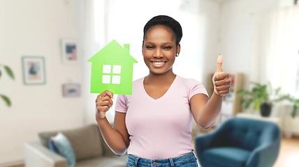 Image showing smiling african american woman holding green house