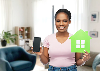 Image showing african woman with smartphone and green house