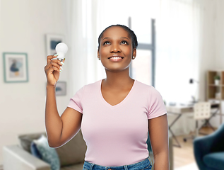 Image showing african american woman holding lighting bulb