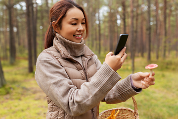 Image showing asian woman using smartphone to identify mushroom