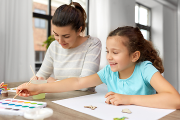 Image showing happy mother with little daughter drawing at home