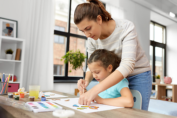 Image showing mother with little daughter drawing at home