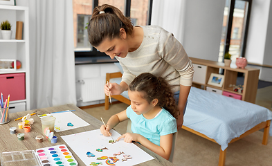 Image showing mother with little daughter drawing at home