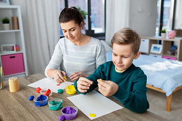 Image showing mother and son playing with modeling clay at home