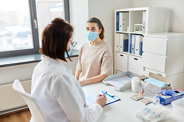 Image showing doctor with clipboard and patient at hospital