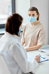 Image showing doctor with clipboard and patient at hospital