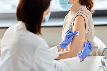 Image showing close up of doctor attaching patch to patient