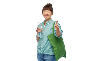 Image showing woman with bag for food shopping and glass bottle