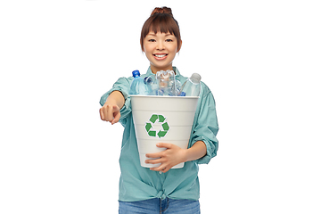 Image showing smiling young asian woman sorting plastic waste