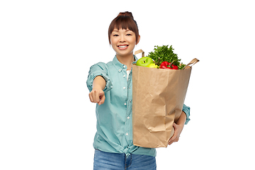 Image showing happy asian woman with food in paper shopping bag
