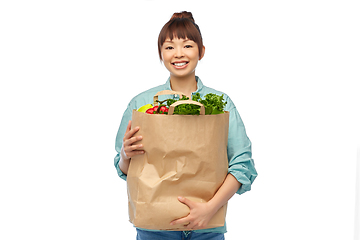 Image showing happy asian woman with food in paper shopping bag