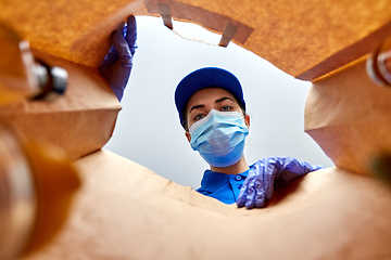 Image showing delivery girl in gloves and mask with food in bag