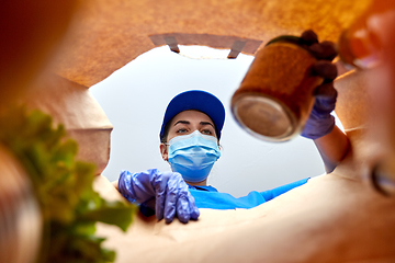 Image showing delivery girl in gloves and mask with food in bag