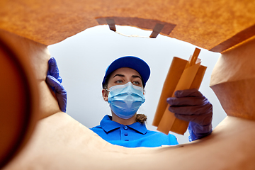 Image showing delivery girl in gloves and mask with food in bag