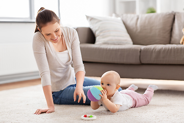 Image showing happy smiling mother with little baby at home