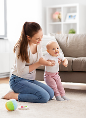 Image showing happy mother playing with little baby at home