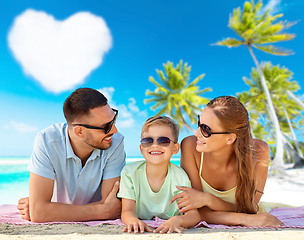 Image showing happy family lying over tropical beach background