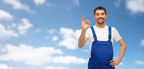 Image showing happy smiling male worker or builder showing ok