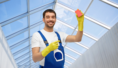 Image showing male cleaner cleaning with sponge and detergent