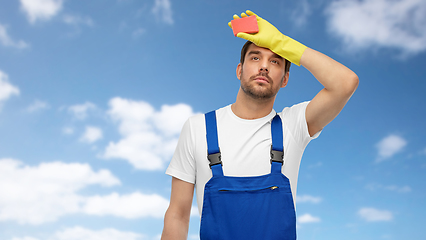 Image showing tired male cleaner with sponge