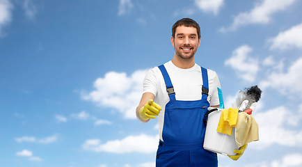 Image showing male cleaner in overall with cleaning supplies